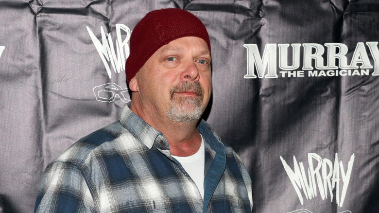 Rick Harrison poses in red beanie in 2023