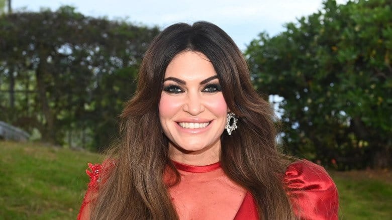 Kimberly Guilfoyle smiling wearing revealing red gown