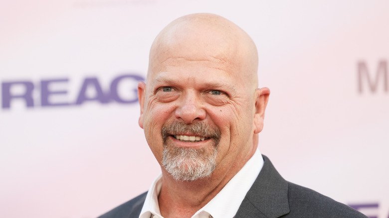 Rich Harrison smiles in gray suit in 2024