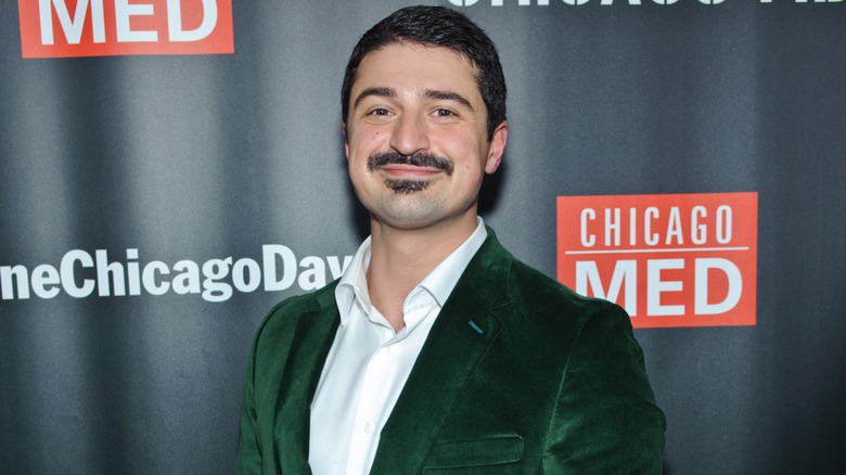 Yuri Sardarov smiling in green velvet blazer