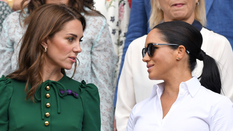 Kate Middleton looking at Meghan Markle