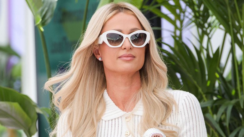 Paris Hilton fanning herself on stage at the Cannes Lions festival.