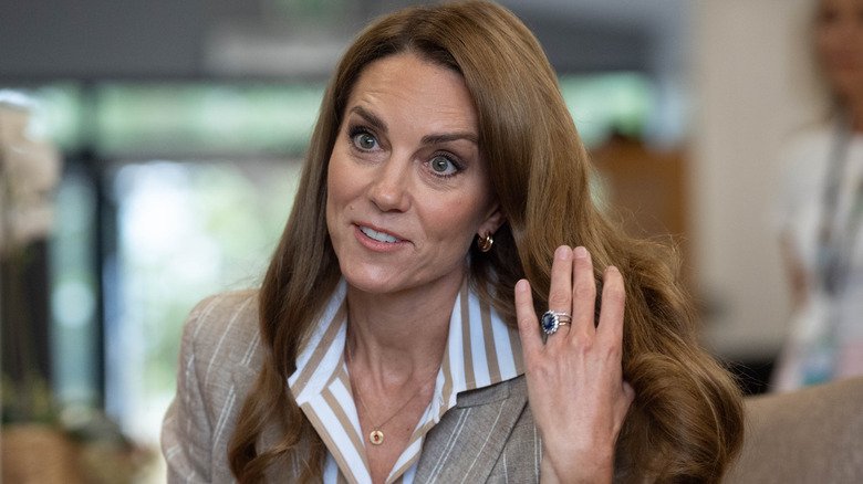 Kate Middleton grabbing her hair at the wellbeing garden