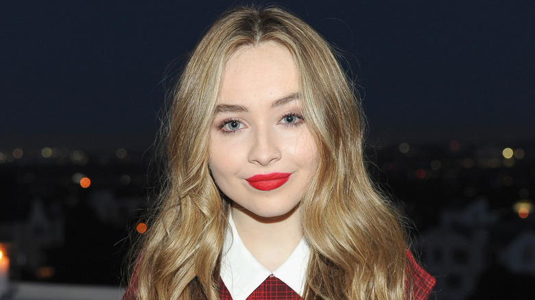 Sabrina Carpenter posing in red lipstick