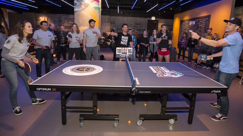 Torrey DeVitto and Jesse Lee Soffer playing table tennis at a 'One Chicago' cast event.