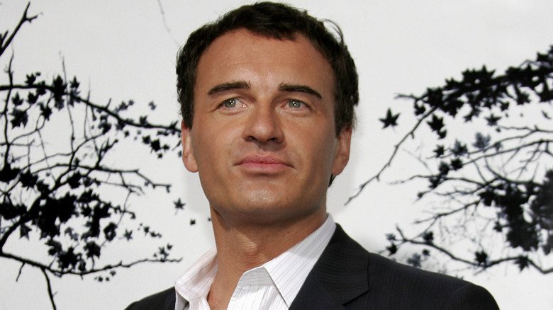 Julian McMahon wearing black blazer and white button-down shirt
