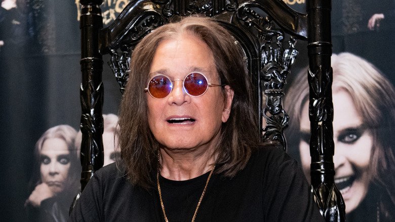 Ozzy Osbourne seated at a table