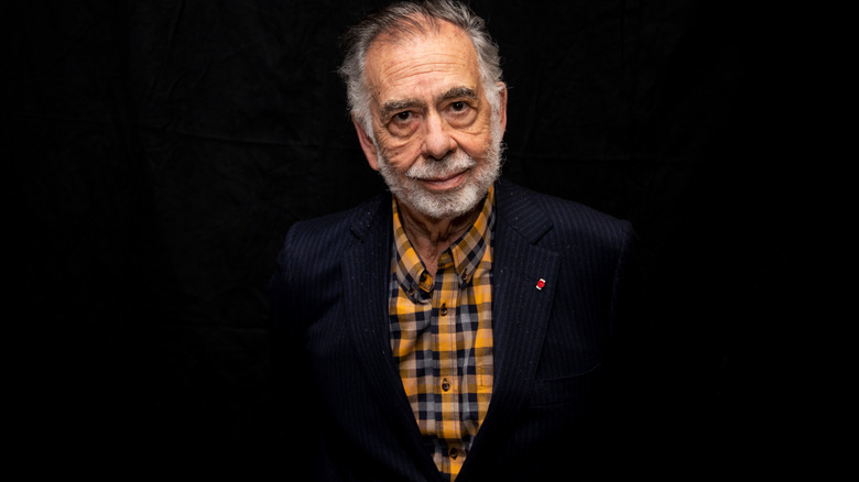 Francis Ford Coppola posing in a plaid shirt