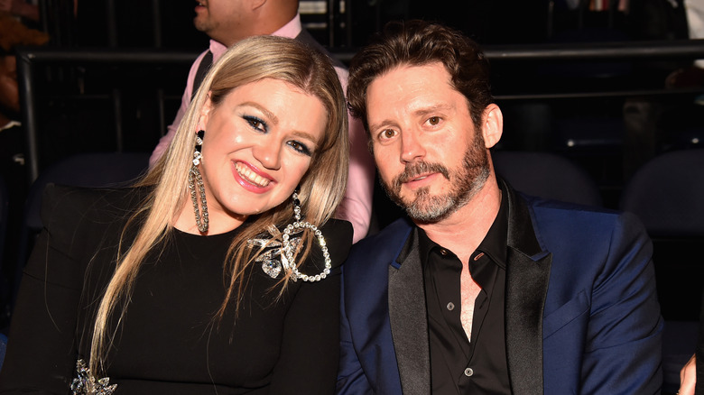 Kelly Clarkson and Brandon Blackstock sitting side-by-side